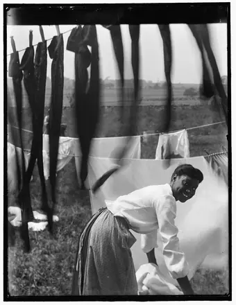 Black and white, an informal portrait of a young Negro woman surrounded by laundry in Newp — Käsebier, Gertrude, 1852-1934, photographer